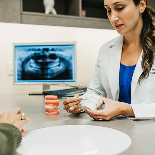 Dr. Patra has extensive knowledge with Invisalign Dr. Patra Alatsis talking to a patient
