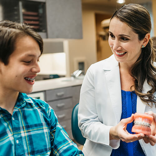 DrPatrawithyoungpatientholdingmodel Gig Harbor Orthodontics