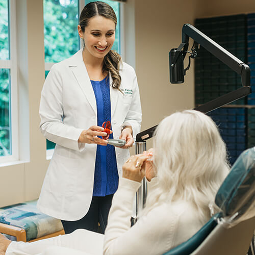 Orthodontist Dr. Patra talking to a patient about Invisalign