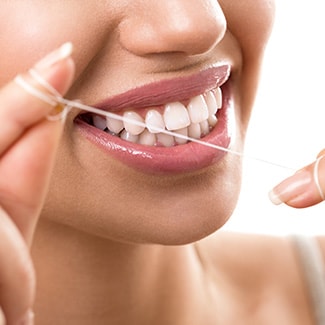 Brush and floss normally Lady flossing her teeth