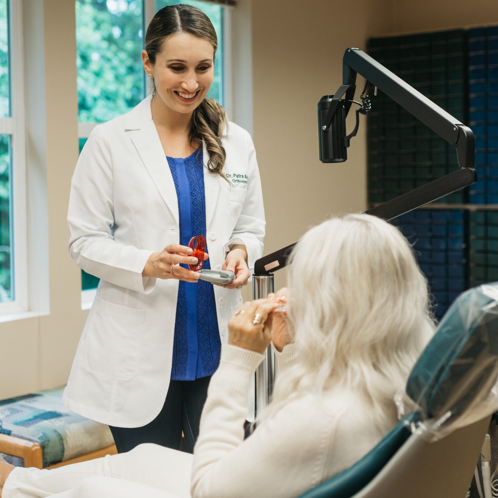 Orthodontist Dr. Patra talking to a patient about Invisalign