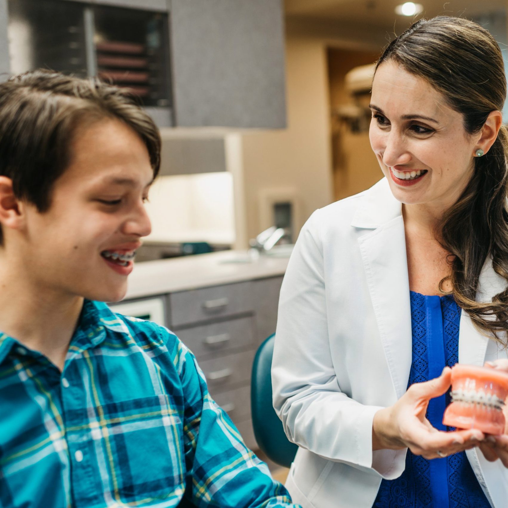 Dr. Patra talking to her teenager patient about braces